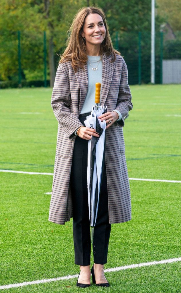 Duchess Kate Visiting The University Of Derbvy In A Plaid Coat And Carrying An Umbrella