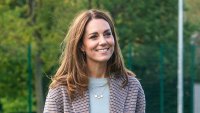 Duchess Kate Visiting The University Of Derbvy In A Plaid Coat And Carrying An Umbrella